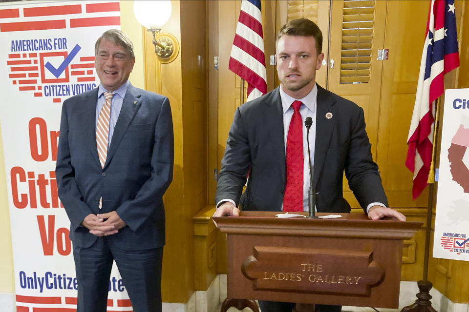 Republican state Reps. Bill Seitz, left, and Jay Edwards, right, co-sponsors of legislation that sent a noncitizen voting prohibition to Ohio's fall ballot, discuss the measure at the Ohio Statehouse in Columbus, Ohio, on Thursday, Oct. 6, 2022. (AP Photo/Julie Carr Smyth)