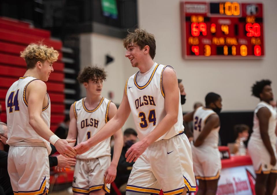 OLSH's Bryson Kirschner, left, and Dawson Summers, two newcomers to the Chargers last year, celebrate as the seconds run down during their WPIAL Class 2A championship win at Peters Township High School last winter.