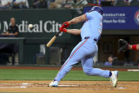 Texas Rangers' Wyatt Langford hits an inside-the-park home run against the Cincinnati Reds in the first inning of a baseball game Sunday, April 28, 2024, in Arlington, Texas. (AP Photo/Richard W. Rodriguez)
