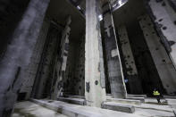 A man walks in the Austerlitz wastewater and rainwater storage basin, which is intended to make the Seine river swimmable during the Paris 2024 Olympic Games, in Paris, during its inauguration Thursday, May 2, 2024. The works underground next to Paris' Austerlitz train station are part of a 1.5 billion euro effort to clean up the Seine so it can host marathon swimming and triathlon events at the July 26-Aug 11 Summer Games and be opened to the general public for swimming from 2025. (Stephane de Sakutin, Pool via AP)