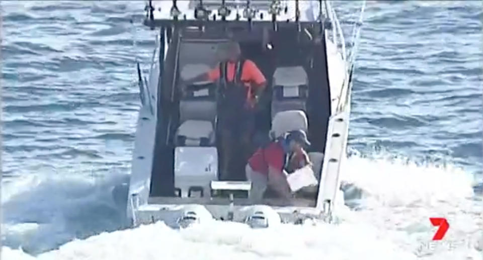 Two fishermen on a sinking boat kilometres off the Sydney coast used buckets in attempt to bail themselves out by hand. Source: 7 News