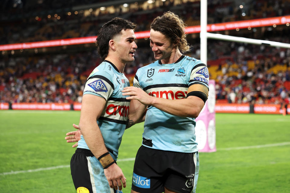BRISBANE, AUSTRALIA - MAY 18: Daniel Atkinson and Nicho Hynes of the Sharks celebrate victory during the round 11 NRL match between Cronulla Sharks and Sydney Roosters at Suncorp Stadium, on May 18, 2024, in Brisbane, Australia. (Photo by Hannah Peters/Getty Images)