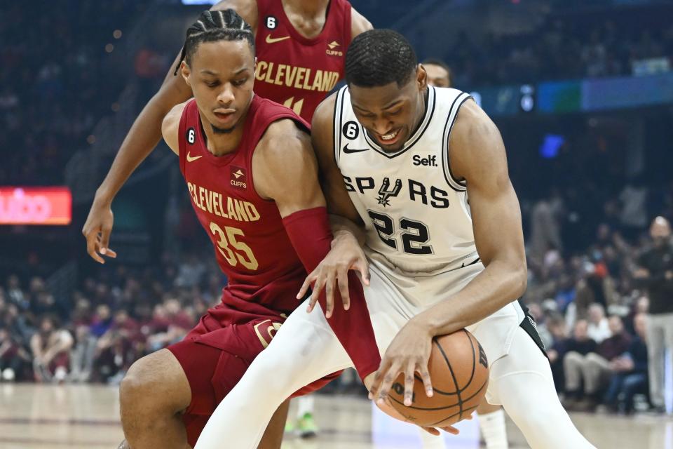 Cavaliers forward Isaac Okoro and San Antonio Spurs guard Malaki Branham fight for the ball during the first half, Monday, Feb. 13, 2023, in Cleveland.