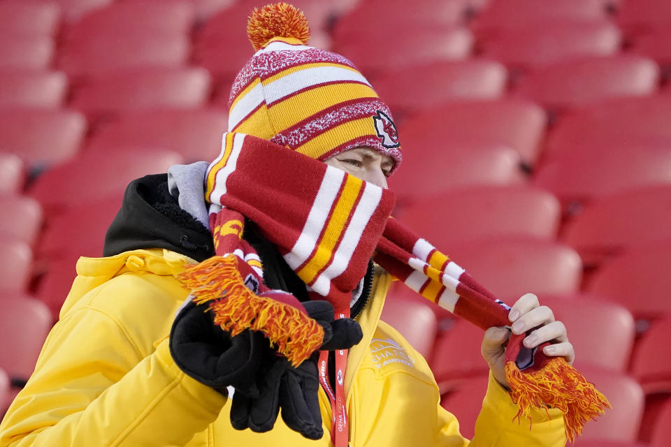 A fan bundles up before an NFL wild-card playoff football game between the Kansas City Chiefs and the Miami Dolphins on Saturday, Jan. 13, 2024, in Kansas City, Mo. (AP Photo/Ed Zurga)