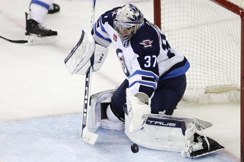 Winnipeg Jets goaltender Connor Hellebuyck (37) makes a save against the New York Rangers in the third period of an NHL hockey game Monday, Feb. 20, 2023, in New York. The Jets won 4-1. (AP Photo/Adam Hunger)