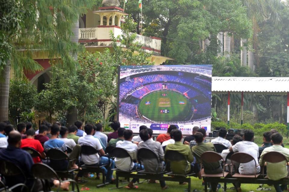 Fans watch the World Cup final on a big screen in Prayagraj.