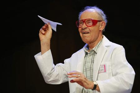 Chemist Dudley Herschbach, winner of the 1986 Nobel Prize for Chemistry, throws a paper airplane during the 23rd First Annual Ig Nobel Prize ceremony at Harvard University in Cambridge, Massachusetts September 12, 2013. REUTERS/Brian Snyder