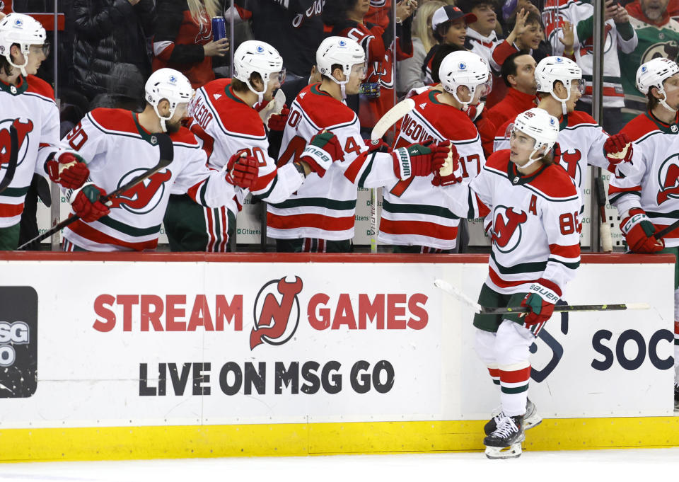 New Jersey Devils center Jack Hughes (86) celebrates with teammates after scoring a goal against the Ottawa Senators during the first period of an NHL hockey game, Saturday, March 25, 2023, in Newark, N.J. (AP Photo/Noah K. Murray)