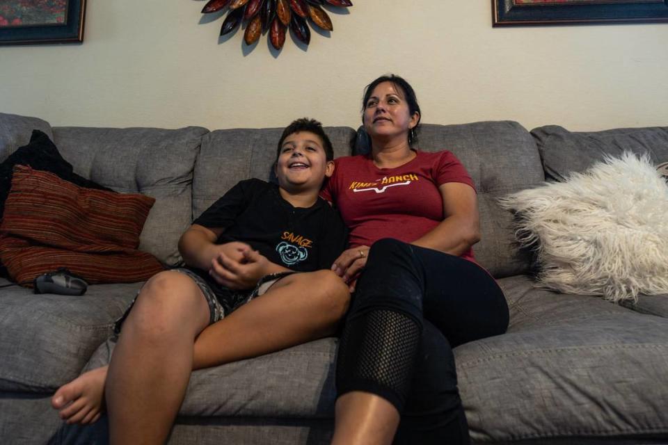 Maria Maldonado spends time with her son Aiden Berger, 9, and her dog Bonnie at her home in Burleson on Wednesday, June 5, 2024. With the pro bono legal aid from Methodist Justice Ministry, she was able to get custody of her son from his drug-addicted father in 2020.