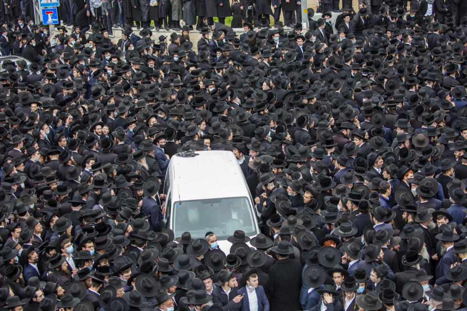 Thousands of ultra-Orthodox Jews participate in the funeral for prominent rabbi Meshulam Soloveitchik, in Jerusalem, Sunday, Jan. 31, 2021. The mass ceremony took place despite the country's health regulations banning large public gatherings, during a nationwide lockdown to curb the spread of the coronavirus. (AP Photo/Ariel Schalit)