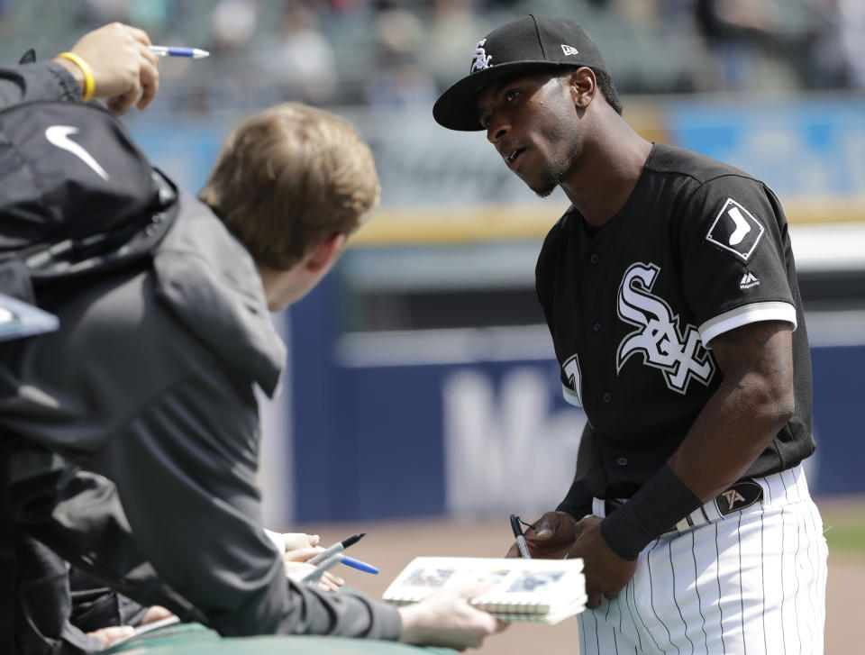 Chicago White Sox's Tim Anderson talks with a fan as signs autographs before a baseball game against the Kansas City Royals in Chicago, Wednesday, April 17, 2019. (AP Photo/Nam Y. Huh)