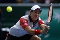 Kei Nishikori of Japan returns a shot during his men's singles tennis match against Jo-Wilfried Tsonga of France in the third round of the Paris Masters tennis tournament at the Bercy sports hall in Paris, October 30, 2014. REUTERS/Benoit Tessier