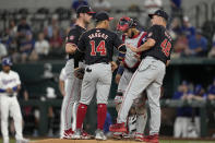 Washington Nationals pitching coach Jim Hickey (48) pays a mound visit to starting pitcher Mitchell Parker, Ildemaro Vargas (14) and catcher Keibert Ruiz, center rear, in the second inning of a baseball game against the Texas Rangers in Arlington, Texas, Thursday, May 2, 2024. (AP Photo/Tony Gutierrez)