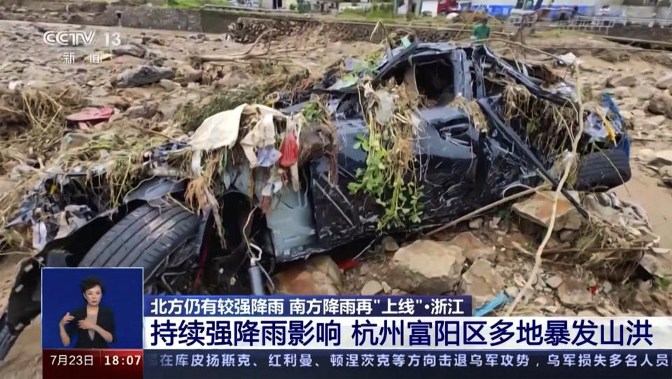 In this image taken from video footage run by China's CCTV, a damaged vehicle are seen in the aftermath of a flood hit Hangzhou in eastern China's Zhejiang province on Sunday, July 23, 2023. Floods caused by heavy rain hit eastern China, leaving at several dead and missing while over thousands of people were evacuated, state media reported on Sunday. (CCTV via AP)