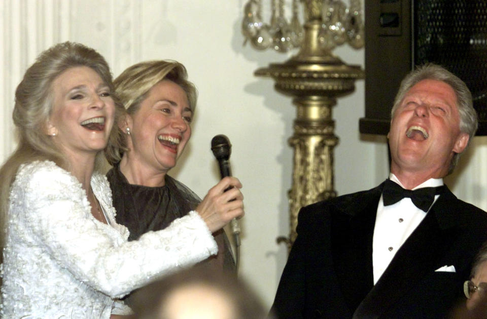 U.S. President Bill Clinton laughs after finishing a rendition of 