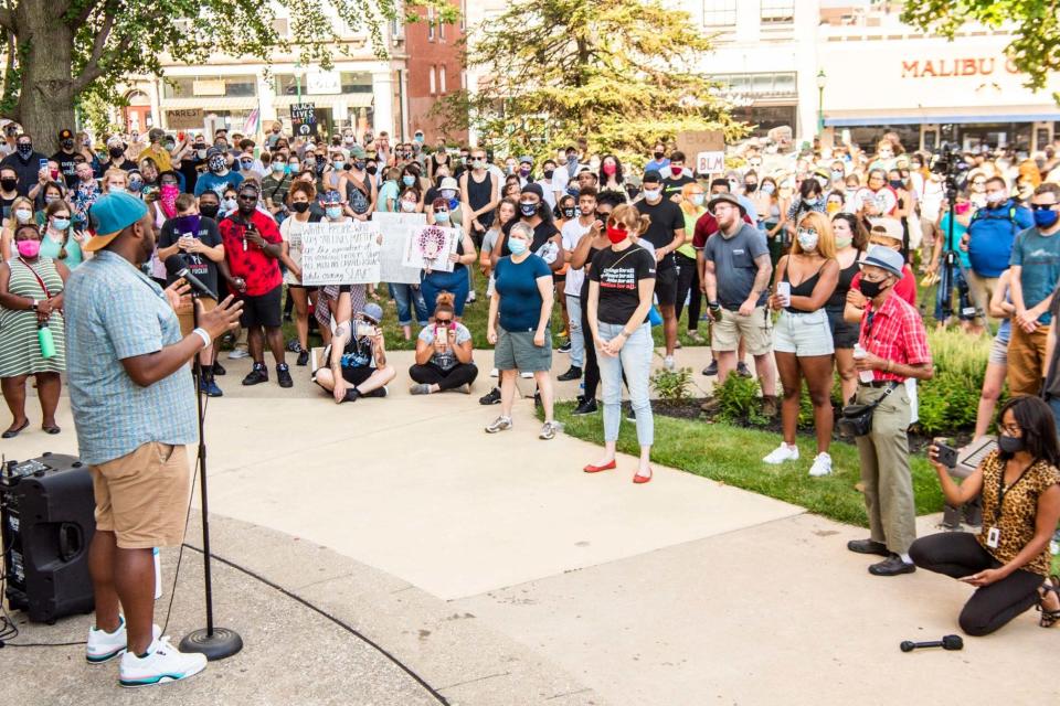 Vauhxx Booker speaks to the hundreds gathered at the Monroe County courthouse on Monday (AP)