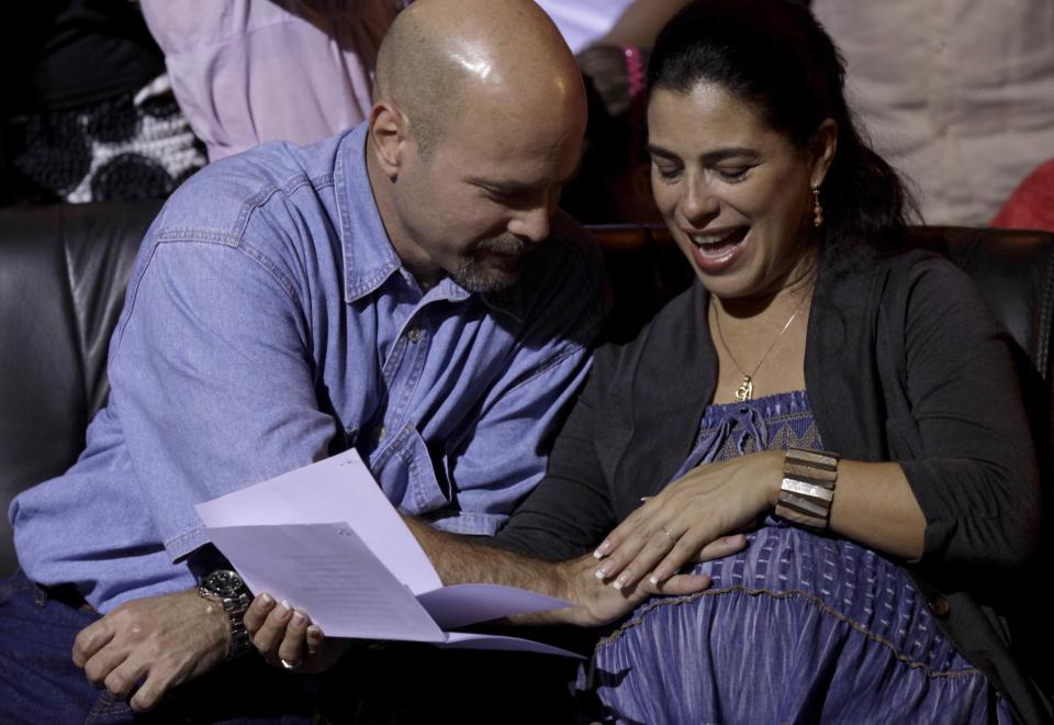 Gerardo Hernandez , one of the so-called &quot;Cuban Five&quot;, reacts with his wife Adriana Perez (R) during Cuban musician Silvio Rodriguez&#39;s concert in Havana December 20, 2014. The United States helped Hernandez, a Cuban spy imprisoned in California artificially inseminate his wife back in Cuba, a goodwill gesture while Washington and Havana were engaged in secret talks on restoring diplomatic ties, U.S. officials said on Monday. Now Hernandez and Adriana are expecting his baby in two weeks, even though he was locked up for 16 years without conjugal visits. It will be a girl called Gema, Cuban official media said. Hernandez was serving a double-life sentence at the U.S. federal penitentiary in Victorville until his release on Wednesday as part of a prisoner swap, which was completed the same day the United States and Cuba announced they would restore diplomatic ties after more than 50 years.  Picture taken December 20, 2014. (Enrique De La Osa/REUTERS)