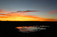 <p>Another dramatic sunset at the Moringa watering hole. It is always worth the price of admission. Sunsets are quiet, with only the sounds of wildlife and cameras clicking. (Photo: Gordon Donovan/Yahoo News) </p>