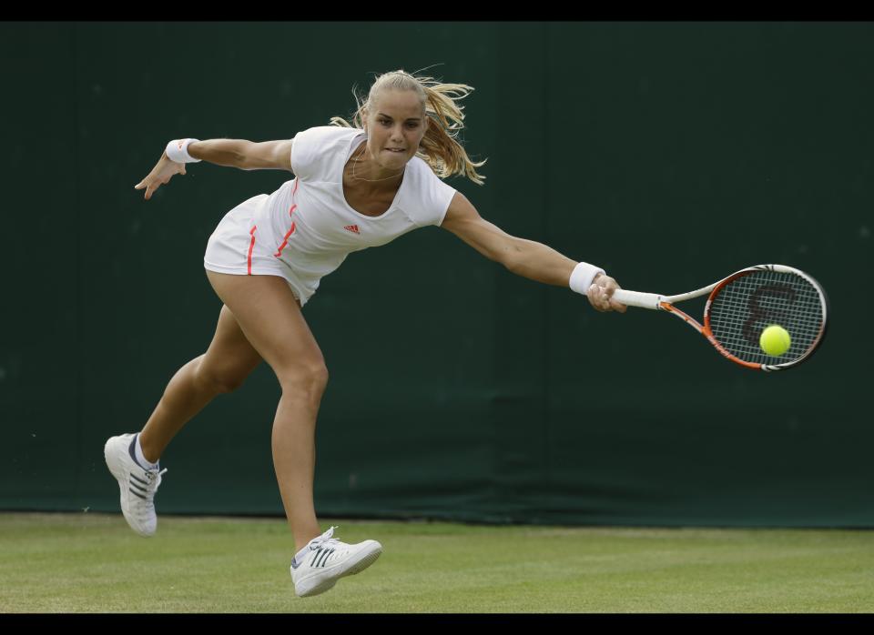 Arantxa Rus of Netherlands returns a shot to Peng Shuai of China during a third round women's singles match at the All England Lawn Tennis Championships at Wimbledon, England, Friday, June 29, 2012.