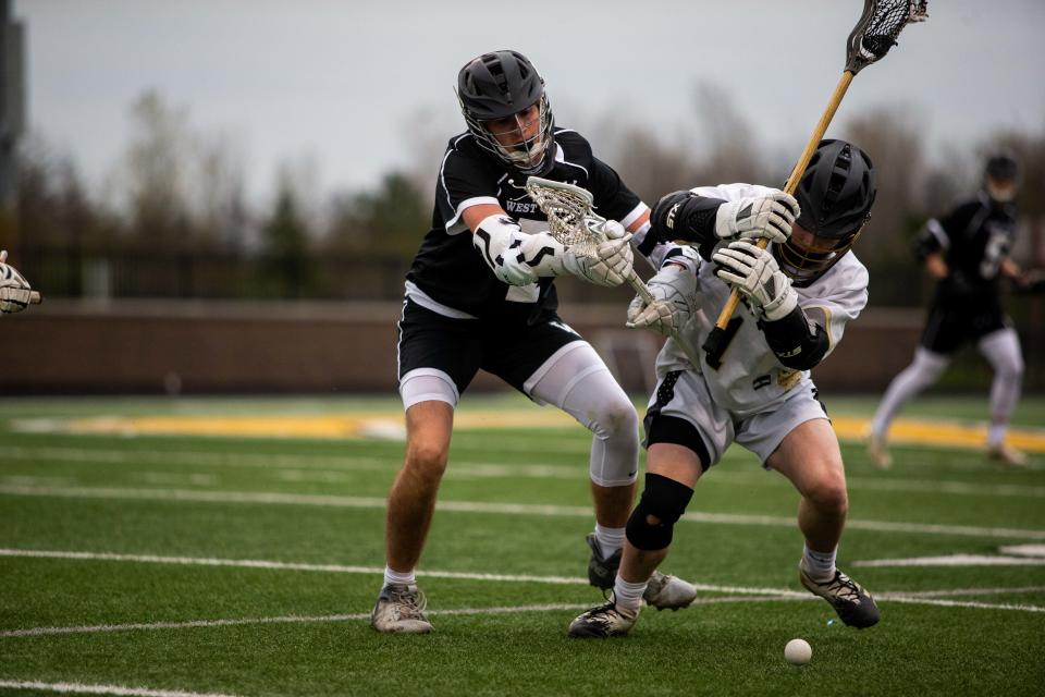 West Ottawa's Trent Mulder tries to keep posession of the ball during a game against Zeeland