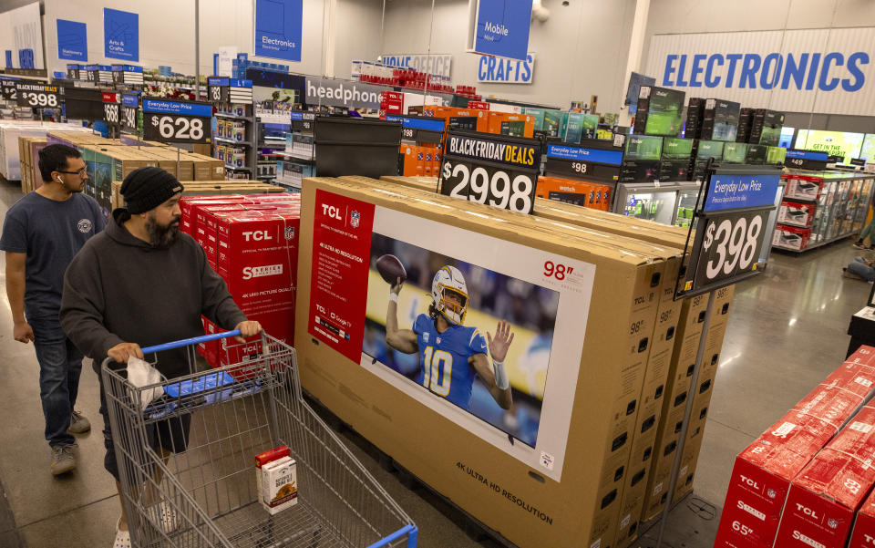 Burbank, CA - November 14: A customer rolls his cart past a Black Friday deal in the electronics department at the Walmart Supercenter on Tuesday, Nov. 14, 2023 in Burbank, CA. (Brian van der Brug / Los Angeles Times via Getty Images)