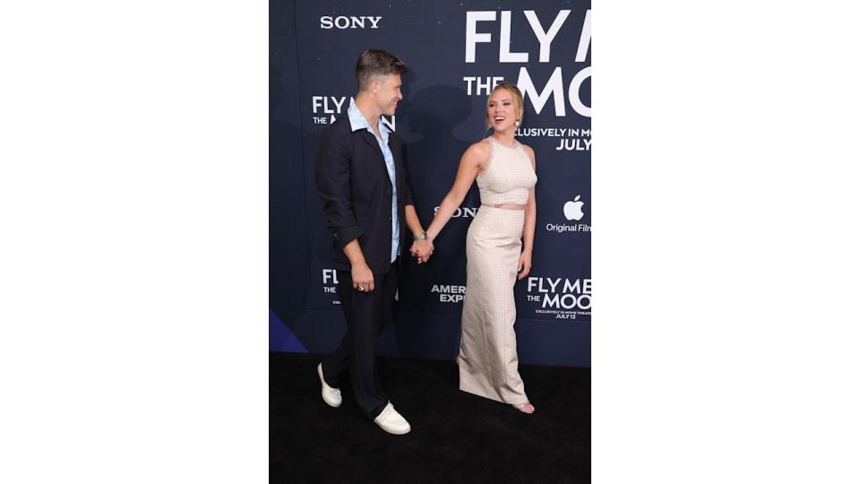 Colin Jost and Scarlett Johansson walk hand in hand at the premiere