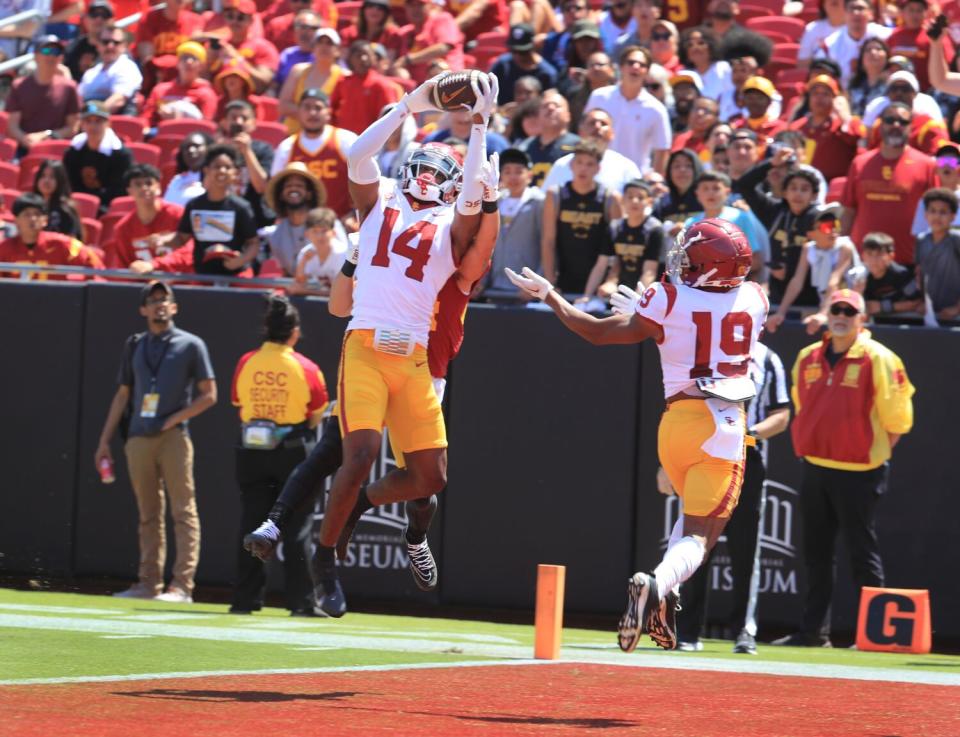 USC defensive back Jacobe Covington catches an interception over USC wide receiver Josiah Zamora