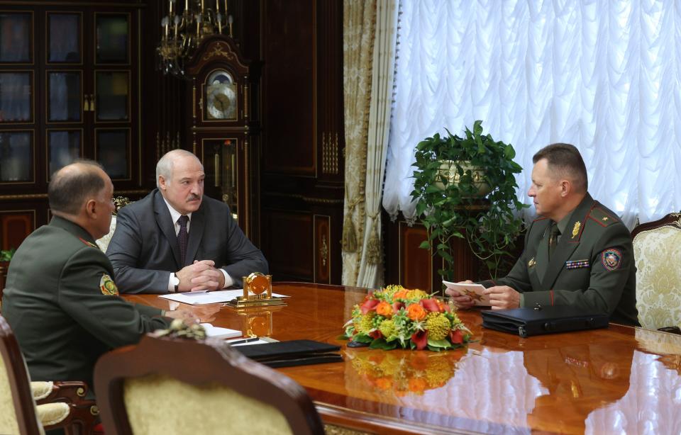 Belarusian president Alexander Lukashenko, centre, held a meeting in Minsk with security officials on Monday (AP)