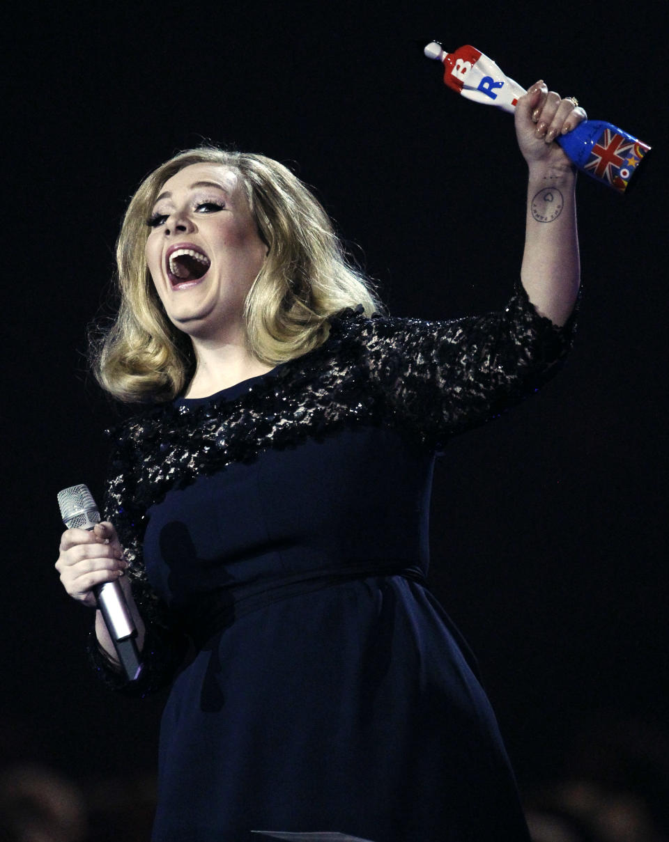 Adele celebrates with the award for the best British Album of the Year during the Brit Awards 2012 at the O2 Arena in London, Tuesday, Feb. 21, 2012. (AP Photo/Joel Ryan)