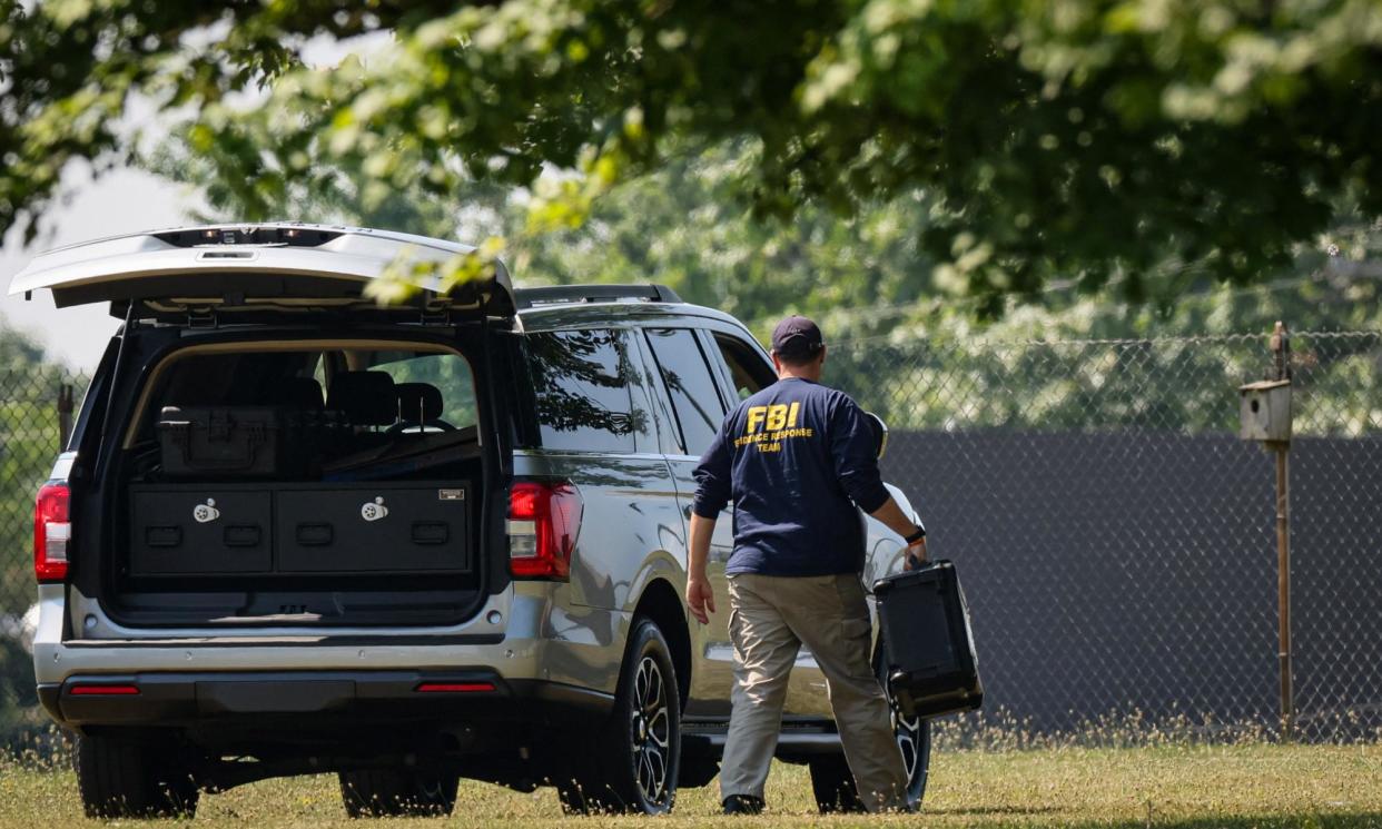 <span>A member of the FBI evidence response team, works near the building where a gunman was shot dead by law enforcement in Butler, Pennsylvania, on Monday.</span><span>Photograph: Brendan McDermid/Reuters</span>