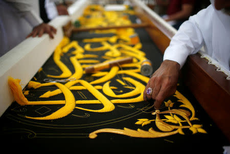 A man embroiders the Kiswa, a silk cloth covering the Holy Kaaba, ahead of the annual haj pilgrimage, at a factory in the holy city of Mecca, Saudi Arabia August 26, 2017. Picture taken August 26, 2017. REUTERS/Suhaib Salem