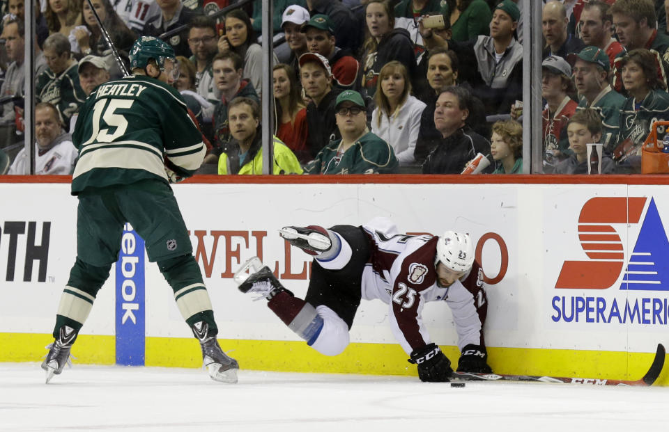 Minnesota Wild left wing Dany Heatley (15) checks Colorado Avalanche center Maxime Talbot (25) off the puck during the second period of Game 6 of an NHL hockey first-round playoff series in St. Paul, Minn., Monday, April 28, 2014. (AP Photo/Ann Heisenfelt)