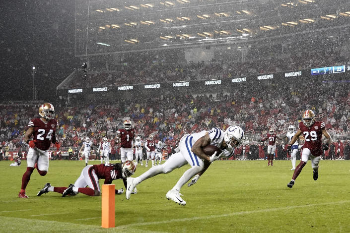 Indianapolis Colts wide receiver Michael Pittman Jr., foreground, runs toward the end zone on his touchdown reception during the second half of an NFL football game against the San Francisco 49ers in Santa Clara, Calif., Sunday, Oct. 24, 2021. (AP Photo/Tony Avelar)