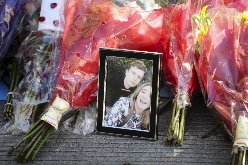 Flowers and a framed photograph mark a makeshift memorial near the scene of a 4th-story apartment building balcony collapse in Berkeley, California