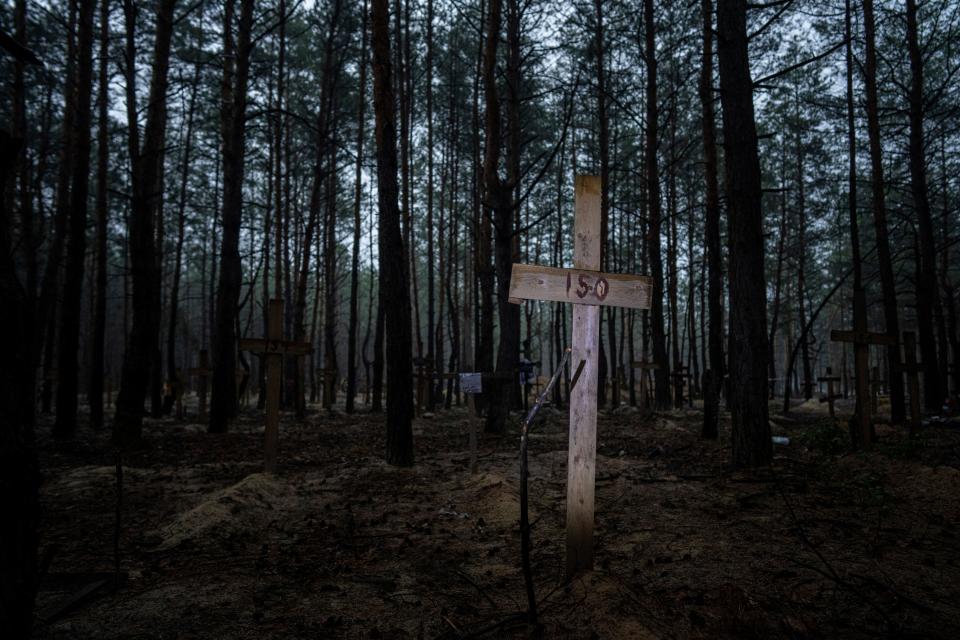 A view of unidentified graves of civilians and Ukrainian soldiers (AP)