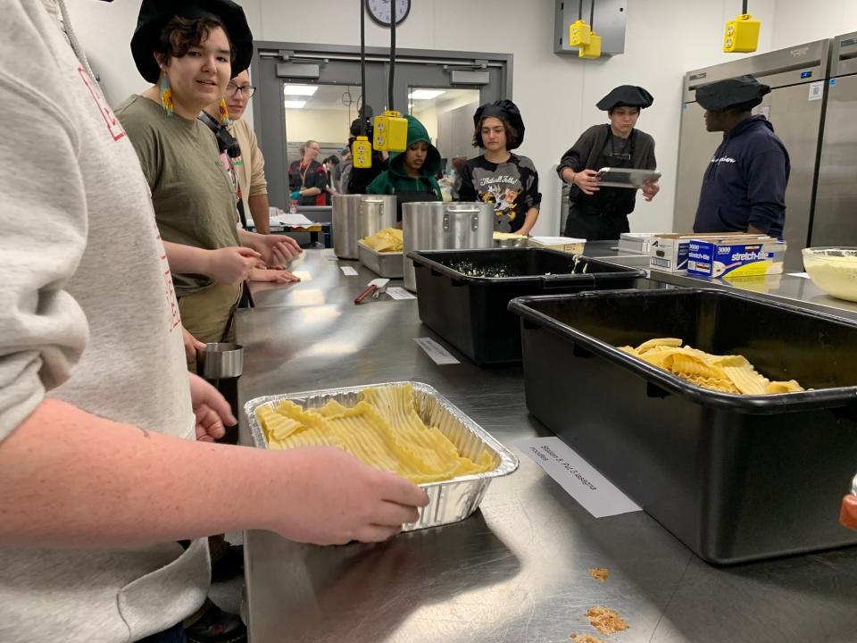 East High culinary students assemble lasagnas for Eats for East at East High School on November 10, 2022 in Green Bay, Wisconsin.