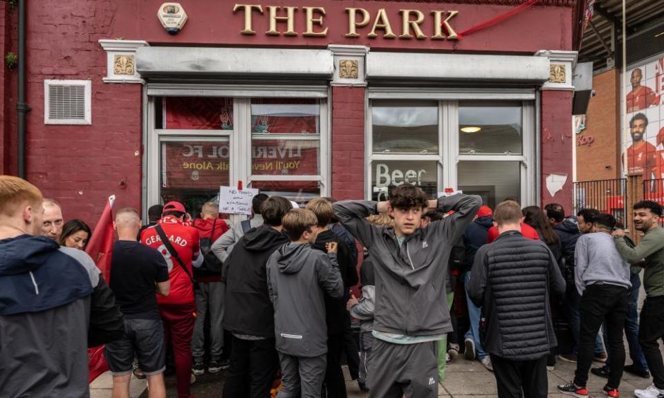 Liverpool fans watch the Premier League match on TV from outside the Park pub on 22 May.