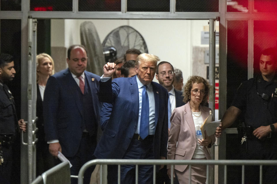 Former President Donald Trump, followed by his lawyer Susan Necheles, right, and advisor Boris Epshteyn, second from left, gestures as he returns to the courtroom following a break in his trial at Manhattan Criminal Court in New York, Thursday, May 9, 2024. (Victor J. Blue/The Washington Post via AP, Pool)