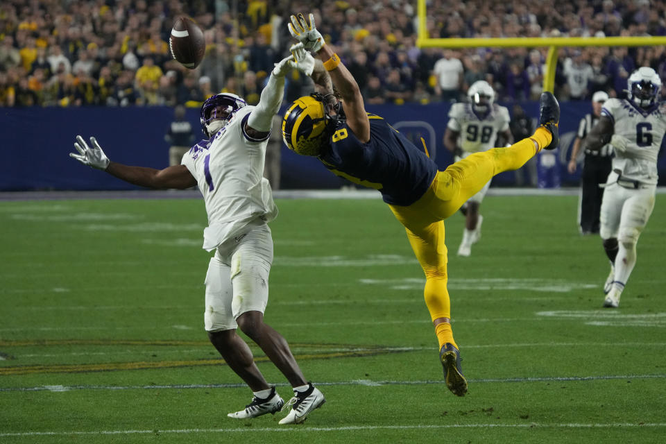 Michigan wide receiver Ronnie Bell (8) can't make the catch as TCU cornerback Tre'Vius Hodges-Tomlinson (1) defends during the second half of the Fiesta Bowl NCAA college football semifinal playoff game, Saturday, Dec. 31, 2022, in Glendale, Ariz. Hodges-Tomlinson was called for pass interference on the play. (AP Photo/Rick Scuteri)