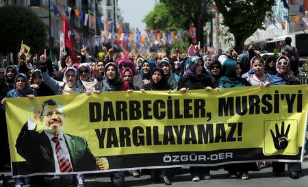 Pro-Islamist demonstrators hold a banner that reads "Coup leaders can't trial Mursi" during a protest in support former President Mohamed Mursi at the courtyard of Fatih mosque in Istanbul, Turkey, May 17, 2015. REUTERS/Yagiz Karahan