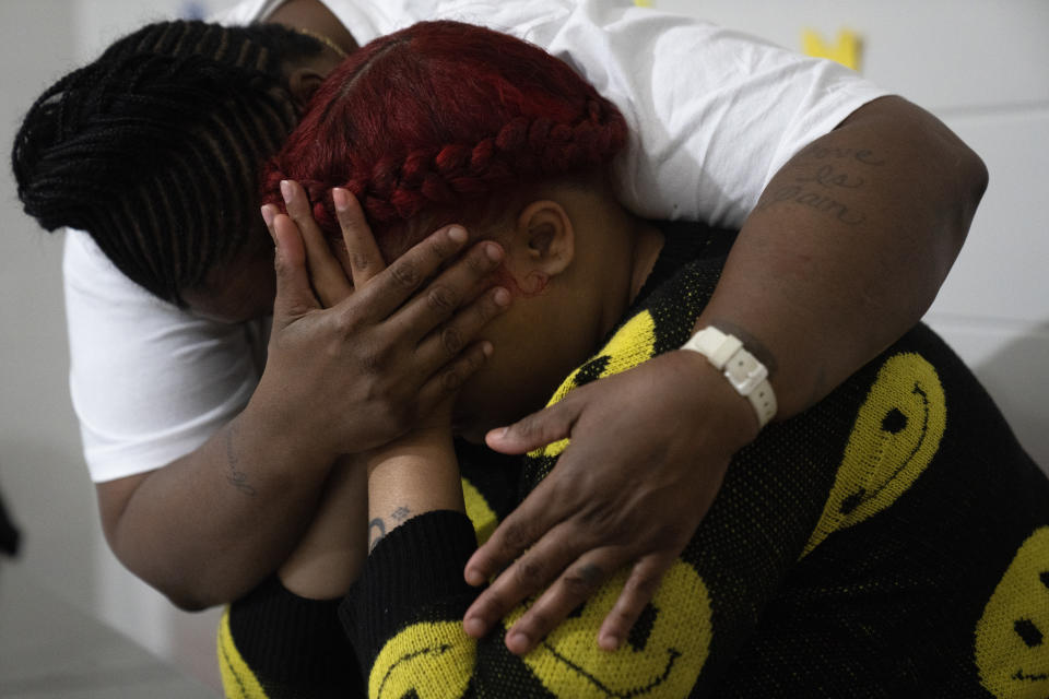 Latonya Dextra, left, comforts her emotional 27-year-old daughter Nyia Pritchett during a special visit at Logan Correctional Center, Saturday, May 20, 2023, in Lincoln, Illinois. Pritchett hadn't seen her mother for three years. Rare programs like the Reunification Ride, a donation-dependent initiative that buses prisoners' family members from Chicago to Illinois' largest women's prison every month so they can spend time with their mothers and grandmothers, are a crucial lifeline for families, prisoners say. (AP Photo/Erin Hooley)