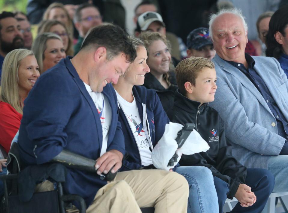 Retired U.S. Army Sgt. 1st Class Ryan Davis is all smiles as he sits with his wife Asia and their son Knox during a dedication ceremony for their new custom built SMART home on Thursday, October 12, 2023 in Richmond Hill.