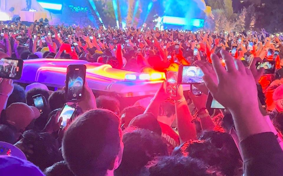 An ambulance makes its way through the crowd at the Astroworld festival in Houston - Reuters