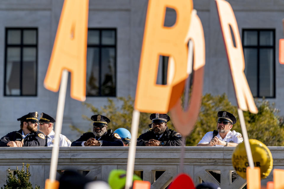 Police officers watch as abortion rights advocates and anti-abortion protesters demonstrate in front of the U.S. Supreme Court, Wednesday, Dec. 1, 2021, in Washington, as the court hears arguments in a case from Mississippi, where a 2018 law would ban abortions after 15 weeks of pregnancy, well before viability. (AP Photo/Andrew Harnik)