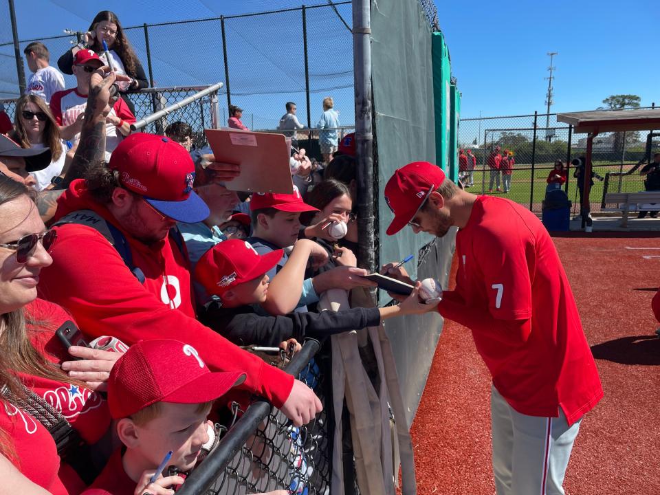 Phillies shortstop Trea Turner signs autographs for fans watching spring training in Clearwater last week.
