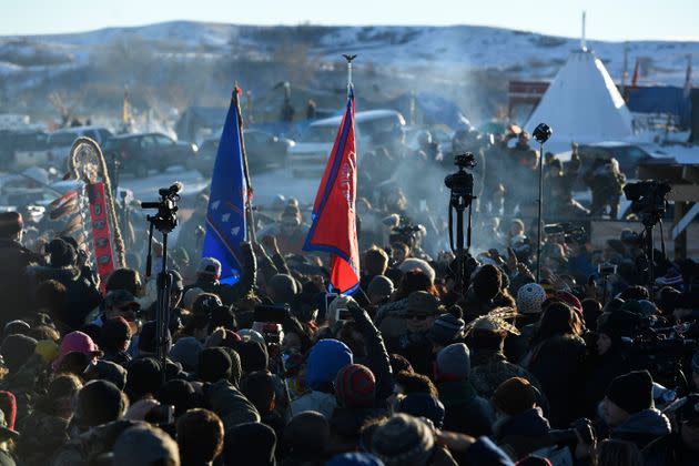 Protesters at Oceti Sakowin camp in Cannon Ball North Dakota celebrate on Dec. 4, 2016, after Sioux Chief Arvol Looking Horse announced to members of over 300 nations that the U.S. Army Corps of Engineers would no longer grant access to build the Dakota Access Pipeline on the boundary of the Standing Rock Sioux Reservation. Native Americans and activists from around the country had been gathering at the camp for several months trying to halt the construction of the pipeline. (Photo: Photo by Helen H. Richardson/The Denver Post via Getty Images)