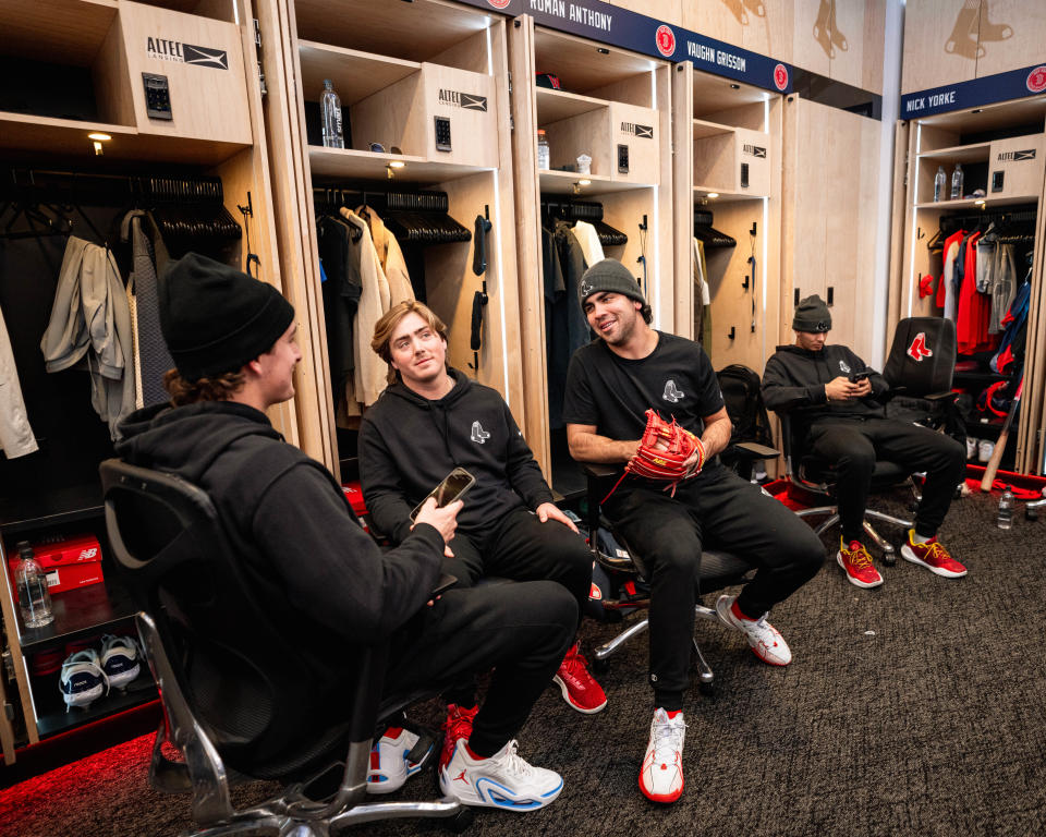 A few of the Boston Red Sox's top prospects, from left, Roman Anthony, Nathan Hickey and Marcelo Mayer talk inside the Red Sox clubhouse at Fenway Park as part of the Red Sox Development Program in mid-January.