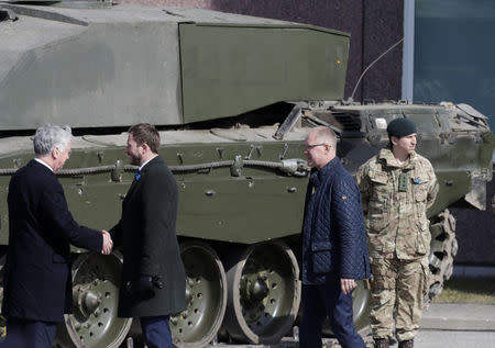 Estonia’s Defence Minister Margus Tsahkna greets Britain's Defence Secretary Michael Fallon (L) during the official ceremony welcoming the deployment of a multi-national NATO battalion in Tapa, Estonia, April 20, 2017. REUTERS/Ints Kalnins