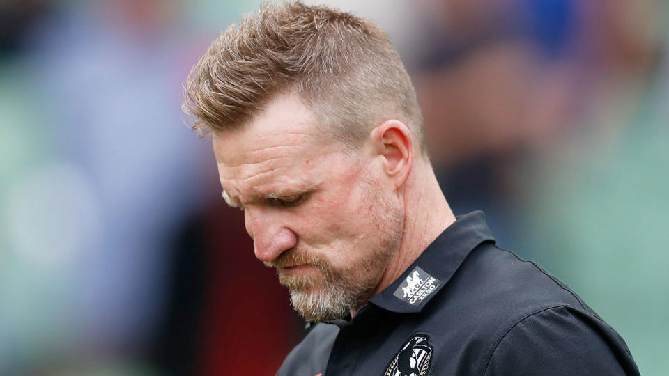 Pictured here, Nathan Buckley looks disappointed after a Collingwood game.