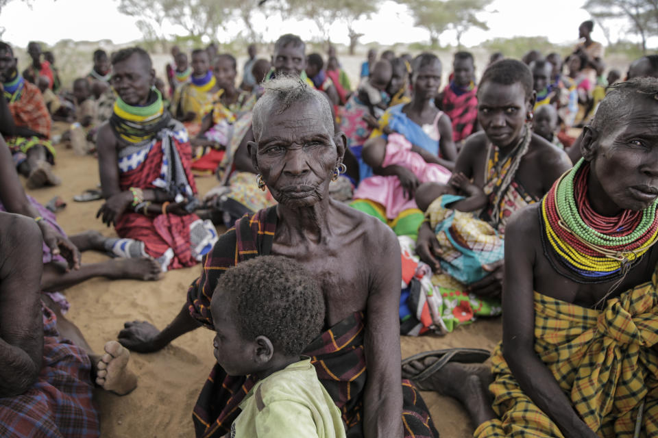 Villagers gather during a visit by United Nations Under-Secretary-General for Humanitarian Affairs Martin Griffiths, in the village of Lomoputh in northern Kenya Thursday, May 12, 2022. Griffiths visited the area on Thursday to see the effects of the drought which the U.N. says is a severe climate-induced humanitarian emergency in the Horn of Africa. (AP Photo/Brian Inganga)